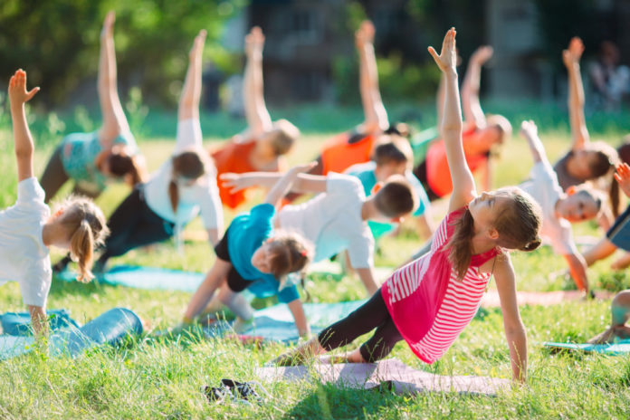 Yoga classes outside on the open air. Kids Yoga,