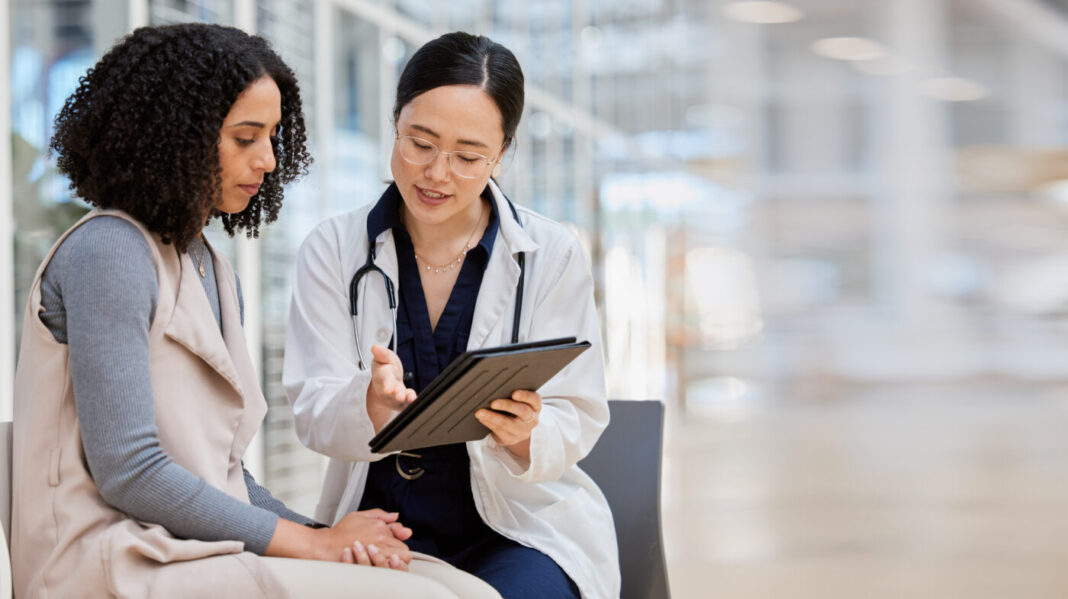 Doctor, woman patient and tablet for consulting with results, medical info and talk for healthcare with mockup space. Japanese medic, digital touchscreen or show video for surgery, wellness or advice.